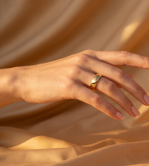 Mudrika Ring in gold, hand reaching toward its silver counterpart